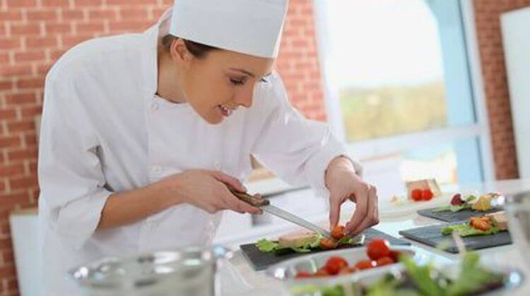 Smiling cook preparing appetizer