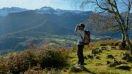 Un homme contemple le Parc National des Pyrénées à l'aide de ses jumelles.