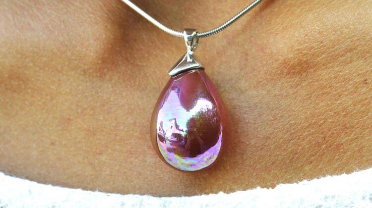 Plan rapproché d'un pendentif sur un collier en nacre violet