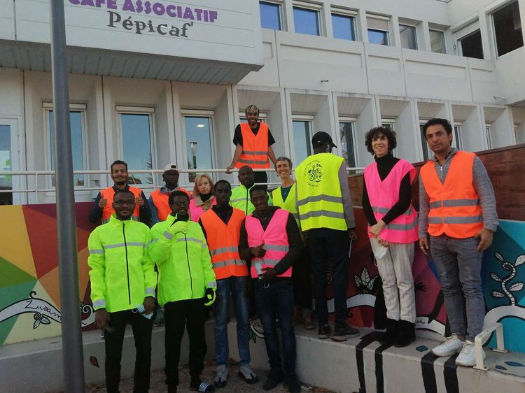 Les conducteurs de Triporteur solidaire du centre social de la Pépinière de Pau réunis autour de Daphné Lecocq, à l'origine du projet, etdevant la structure