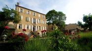 Une vue de la bâtisse et du jardin fleuri à Mirande
